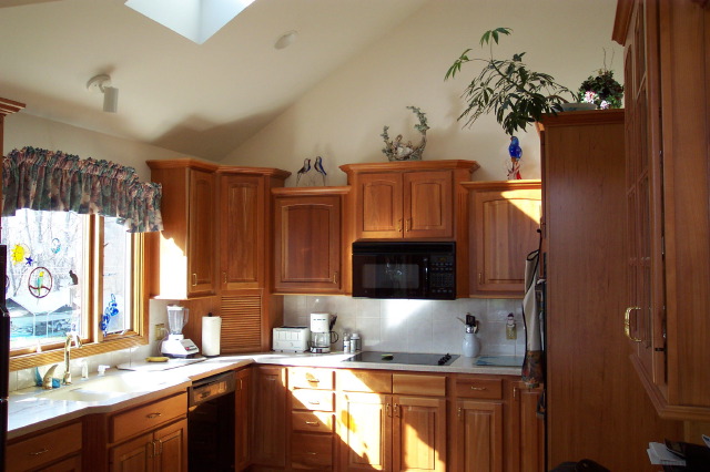 Custom cherry kitchen cabinetry with raised panel doors built by Kitchen-Works