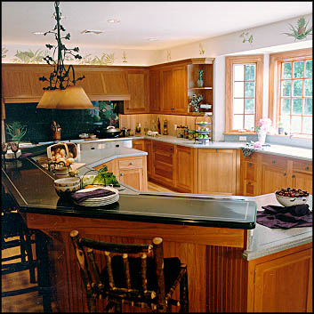 Cherry kitchen with a granite island and seated overhang built by Kitchen-Works