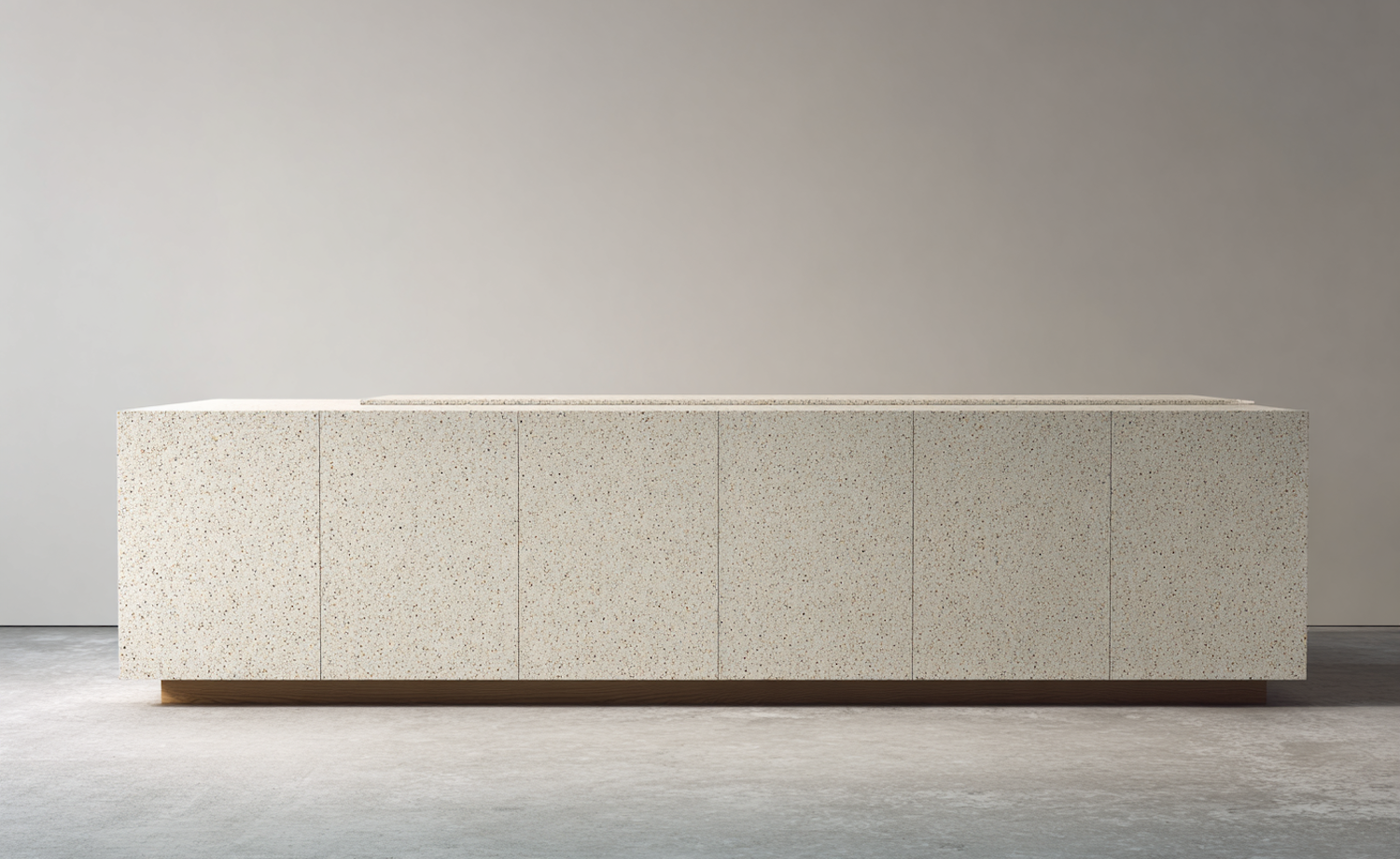 Stone kitchen worktop running along fitted cabinetry